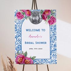 a sign with flowers on it that says welcome to another bridal shower