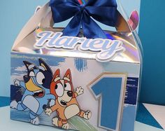 an unopened box with a cartoon character on it and a blue ribbon around the top