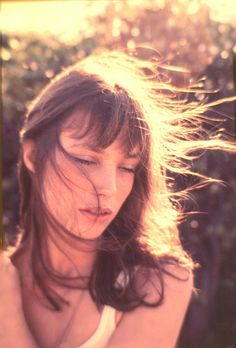 a woman with her hair blowing in the wind