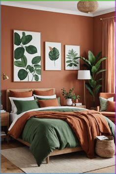 a bedroom with orange walls and green leaves on the wall, bedding is made in an earthy color scheme