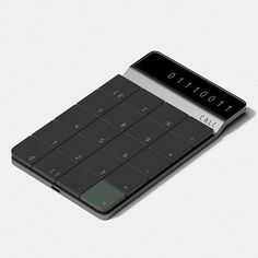 a black calculator sitting on top of a white table