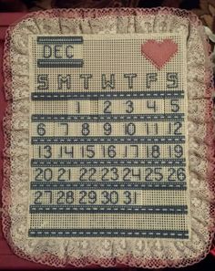 a cross stitch sample with numbers and hearts on it