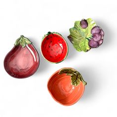 three ceramic fruits and vegetables on a white background