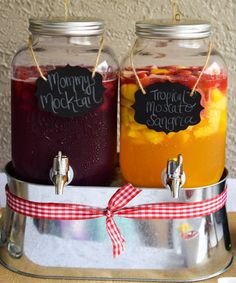 two jars filled with liquid sitting on top of a metal tray next to each other