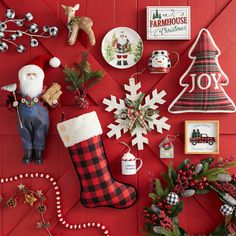 christmas decorations and ornaments are arranged on a red wall