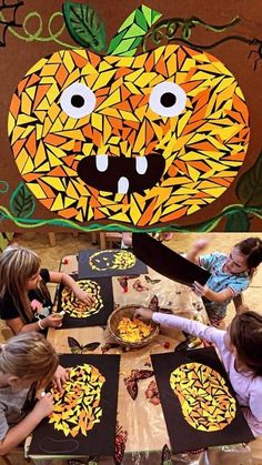 children are painting pumpkins on paper at a table in front of a wall mural