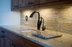 a kitchen counter with a sink and faucet