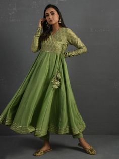 A gold hand block printed 30 kali chanderi overlap kurta in green with gota details and adjustable string tie-ups on both sides. The flared kurta comes with attached mul lining in the yoke and comfortable mul pants with an adjustable elasticated drawstring waistband. Kurta measurements (in Inches): Size S: Bust - 39", Waist - 33" Size M: Bust - 42", Waist - 36" Size L: Bust - 45", Waist - 39" Length: 50", Sleeve length: 30" Pant Measurements (in Inches): Size S: Waist - 30-32" Size M: Waist - 33 Anarkali Outfit, Frock Style Kurti, Wedding Outfits Indian, Full Mehndi, Sangeet Outfit, Frock Style, Kurta Pant Set, Long Kurti, White Maxi Skirts