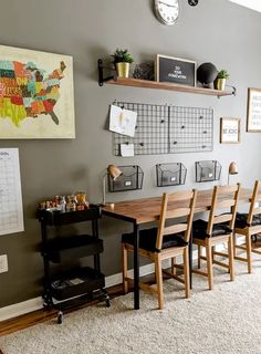 a dining room table and chairs in front of a map