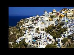 an aerial view of white buildings and blue water