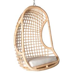 the hanging chair is made out of rattan and has a cushion on it's back