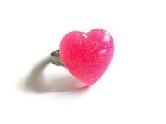 The neon pink heart ring was hand cast in resin and measures 19 x 19mm. The ring band is silver tone and adjustable. Custom colors available. More Allysin rings: http://www.etsy.com/shop/Allysin?section_id=6414116 Have a look at my other shops: Unique gemstone jewelry: http://jewelicide.etsy.com Cute Pink Heart-shaped Rings, Handmade Pink Heart-shaped Ring, Neon Pink Heart, Pink Heart Ring, Pink Heart Rings, Ring Resin, Neon Rose, Glitter Hearts, Unique Gemstones