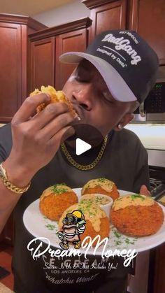 a man is eating some food on a plate in front of his face and wearing a hat