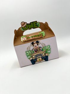 a cardboard box with a mickey mouse on it's lid and the word one is in