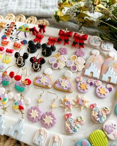 a tray filled with lots of different shaped and colored earring sets on top of a table