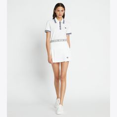 A classic pleated tennis skirt is detailed with Double T knit tape along the waistband and a concealed side zipper for a clean and minimal design. Crafted in tech twill, a lightweight performance fabric engineered to offer stretch, moisture wicking and breathability. Fitted Tennis Dress With Contrast Trim, Sporty Fitted Tennis Skirt With Pleated Waist, Classic White Tennis Skirt, Fitted White Tennis Dress With Contrast Trim, Sporty Cotton Pleated Tennis Skirt, Fitted Cotton Tennis Skirt, Sporty Fitted Tennis Skirt With Contrast Trim, Fitted White Tennis Skirt With Contrast Trim, White Fitted Tennis Skirt With Contrast Trim