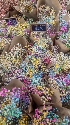 many different colored flowers are on display for sale