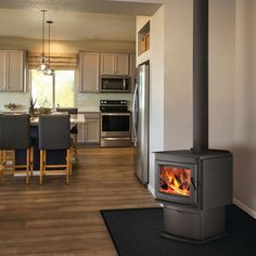 Napoleon S20 Wood Stove with Pedestal offers a premium wood stove insert for your home. The unit's contemporary design offers an attractive appearance, while EPA 2020 certification ensures low emissions. A precision "Easy Glide" ash drawer with removable ash pan offers easy cleanup, while a cast door with hidden hinges and an extra large glass viewing area offer attractive views from anywhere in the room. A ceramic fiber baffle system rounds out an impressive design for an impressive unit capable of upgrading any space. UP TO 65,000 BTU’S • 1.9 CU. FT. FIREBOX CAPACITY • BURN TIME: 8 HOURS Overall Dimensions - 34.25" x 26" x 20.5" (Height, Width, Depth) Glass Dimensions - 15.625" x 9.75" (Width, Height) Recommend Blower Kit Ash Pan Optional - Click here Optional Outside air kit Features He Free Standing Wood Burning Stove, Napoleon Fireplace, Stoves For Sale, Heat Recovery Ventilation, Cord Wood, Modern Flames, Hidden Hinges, Steel Railing, Iron Doors