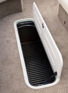 a white surfboard sitting on top of a carpeted floor