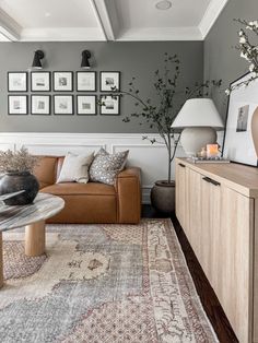 a living room filled with furniture and pictures on the wall