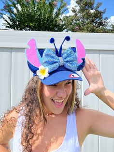 a woman wearing a blue hat with a butterfly on it