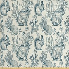 a blue and white fabric with rabbits on it