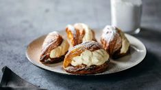 pastries on a plate next to a glass of milk