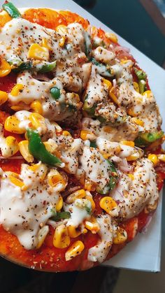 a pizza topped with chicken, peppers and cheese