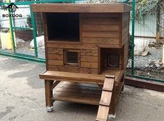 a wooden chicken coop with stairs leading up to it