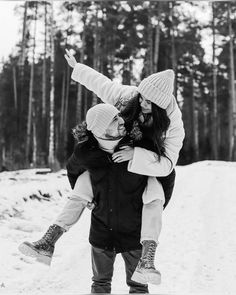 black and white photograph of two girls playing in the snow with their arms around each other