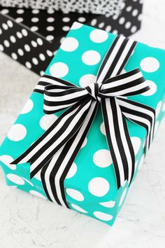 a blue gift box with black and white polka dots on it