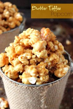 a cup filled with popcorn sitting on top of a table