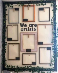 there are many frames on the wall with plants growing around them and one has a sign that says, we are artists