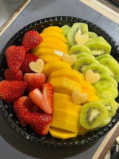 a bowl filled with cut up fruit on top of a counter