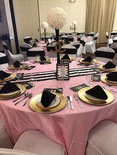 the tables are set with black and gold place settings