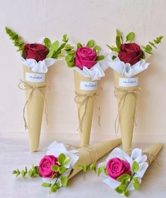 three vases with roses tied to each other