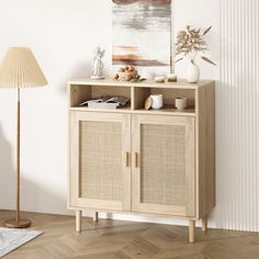 a wooden cabinet with wicker doors in a white living room next to a lamp