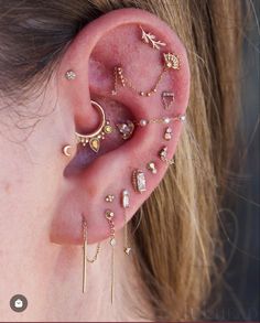 a close up of a person with ear piercings on their ears and behind the ear