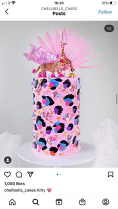 the cake is decorated with pink icing and sprinkles on it's top