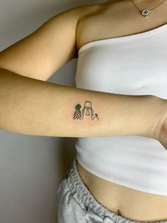 a woman with a small tattoo on her left arm and the word pineapple written in it