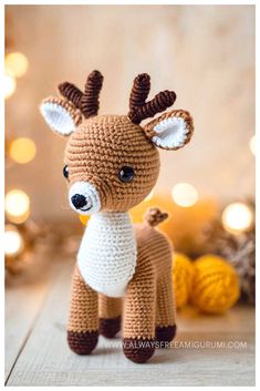 a crocheted deer sitting on top of a wooden floor