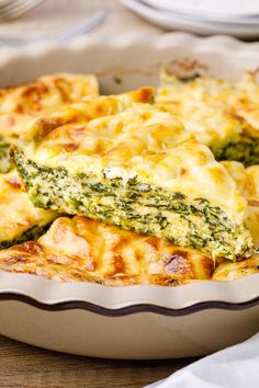 a casserole dish with broccoli and cheese in it on a table