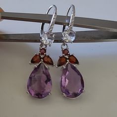 Main Stone: Natural Unheated Purple Amethyst, Garnet, Topaz W/ Cubic Zirconia Metal: .925 Sterling Silver Measurements: Jewelry 10 X 40 Mm Amethyst 9 X 13 Mm Silver Amethyst Multi-stone Earrings, Silver Amethyst Earrings With Multi-stone, Sterling Silver Multi-stone Drop Earrings, Pink Tassel Earrings, Gold Jhumka Earrings, Birthstone Gems, Silver Threader Earrings, Large Stud Earrings, Brass Hoop Earrings