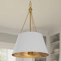 a white lamp hanging from the ceiling in a room