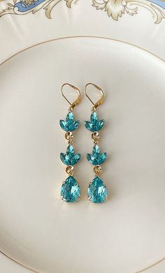 "Pair of long earrings featuring 8x4mm marquise and 14x10mm teal Swarovski crystals. 2 7/8\" long. Thanks for stopping by!" Teal And Gold Jewelry, Elegant Turquoise Drop Crystal Earrings, Elegant Turquoise Drop Teardrop Earrings, Elegant Turquoise Teardrop Earrings For Party, Elegant Turquoise Teardrop Earrings, Lady Aesthetic, Long Crystal Earrings, Teal Earrings, Earrings Chandelier