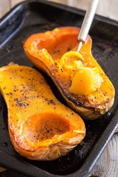 two baked delicacies on a baking sheet with a spatula in the middle