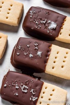 chocolate dipped shortbreads are arranged on a baking sheet and ready to be eaten