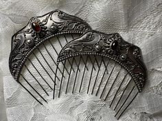 This pair of decorative silver hair combs is marked 925 but have no maker's mark. They were likely brought back by the Dutch from Indonesia around the turn of the century. Moonstone (see other comb listing) and Amber are both found in that region and reached the height of popularity in jewelry during the late Victorian period (Edwardian through Art Nouveau). The silverwork itself is consistent with traditional Balinese silverwork techniques, and the Dutch controlled a large portion of Bali durin Antique Hair Combs, Decorative Hair Combs, Silver Hair Comb, Victorian Period, Turn Of The Century, Hair Combs, Maker's Mark, Balinese, Silver Hair