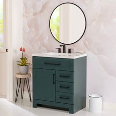 a bathroom vanity with a round mirror above it and a potted plant on the side