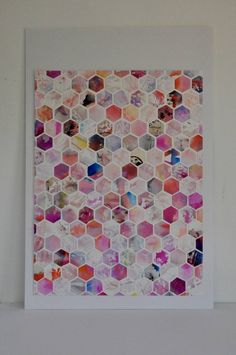 an art work with hexagonal tiles on the wall in front of a white background